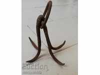 An old forged scraping hook, a quadruped neck