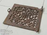 Grill a door embossed cast iron on a masonry stove fireplace jam