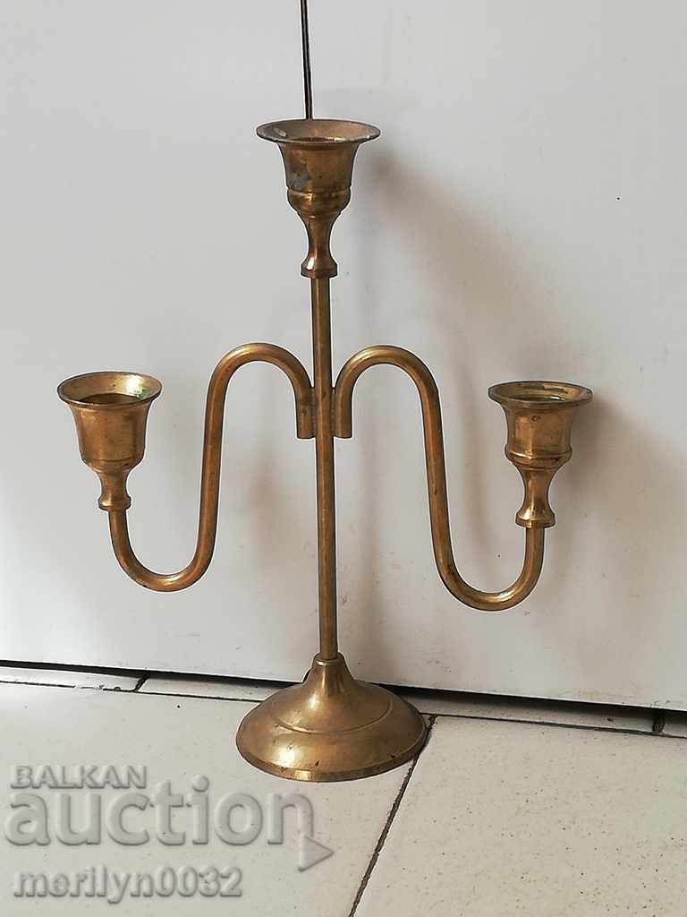 An old candle made of brass candle, candelabra