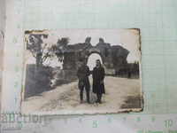 An old image of a soldier and a woman in front of a southern gate in the town of Hissarya