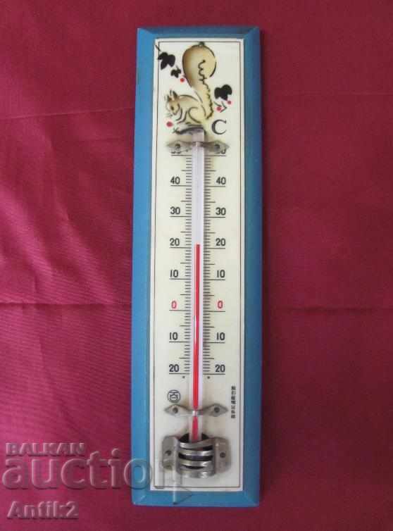 Old room thermometer on wooden base