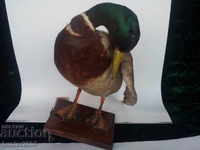 Duck greenhead, detergent,. On a wooden stand.