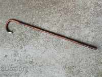 An old cane made of wood silver hardware. of the 20th century