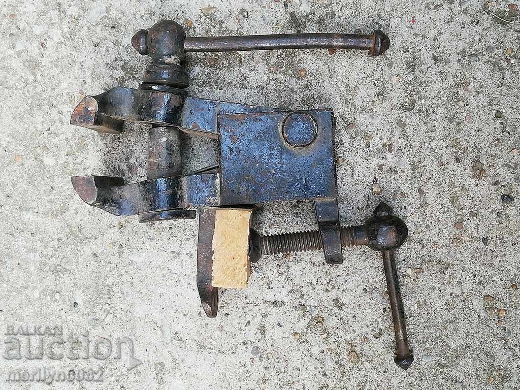 Auction  An old vise clamps a hardware tool