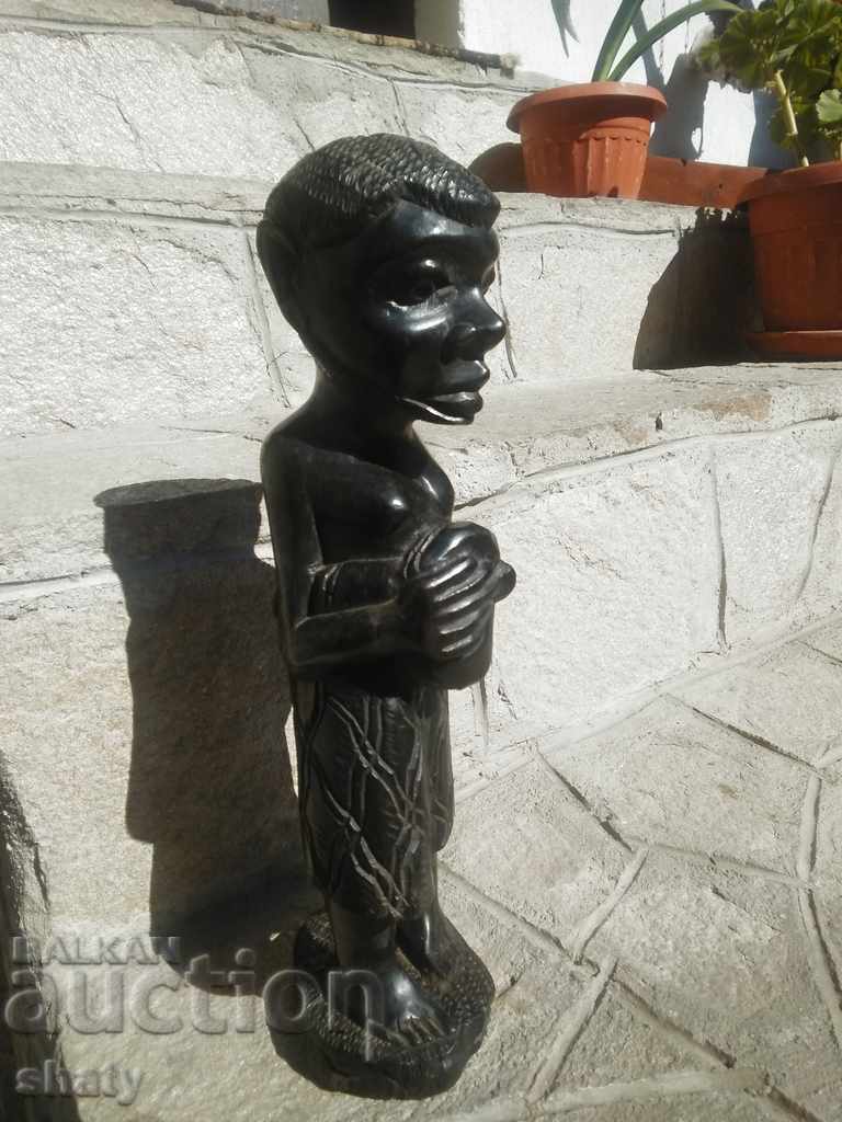 An old ebony figure. Wooden sculpture.