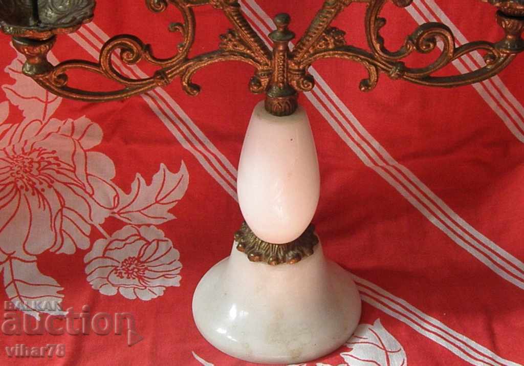 Delivery of old metal candlestick with marble