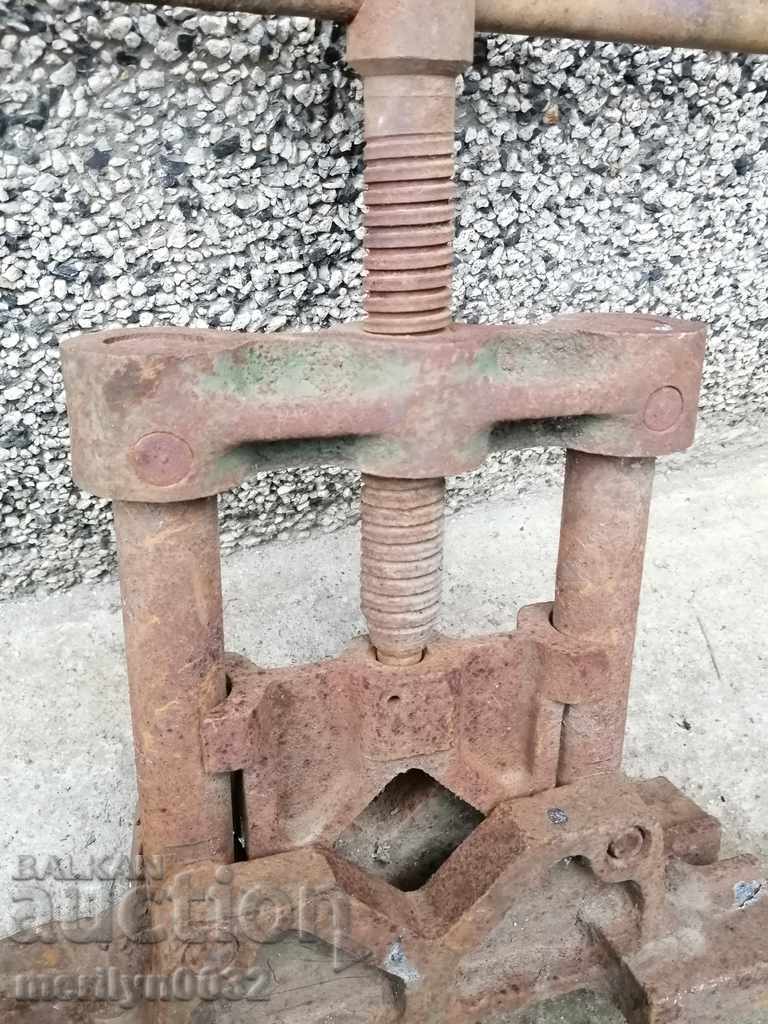 An old pipe clamp clamps an iron tool - 5