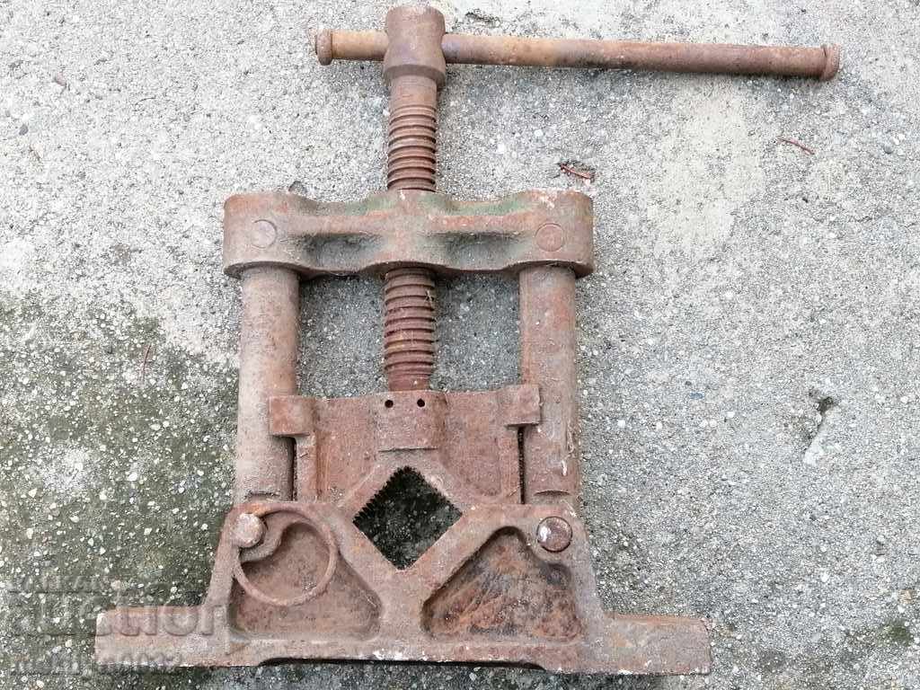 An old pipe clamp clamps an iron tool - 6