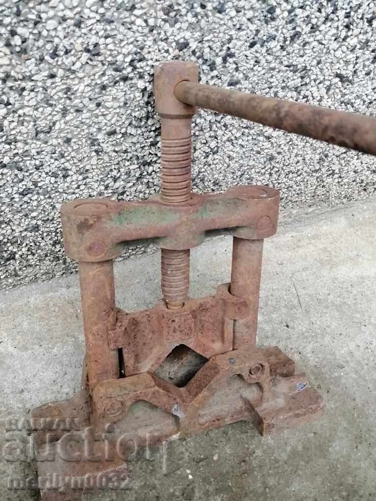 An old pipe clamp clamps an iron tool - 7