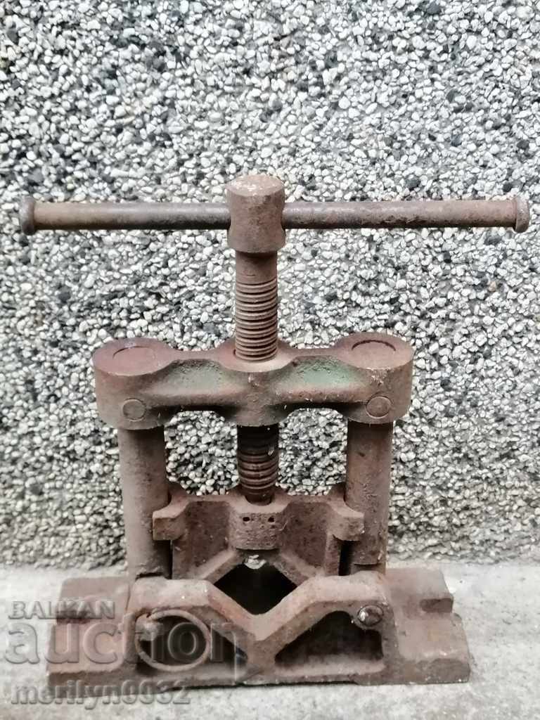 An old pipe clamp clamps an iron tool