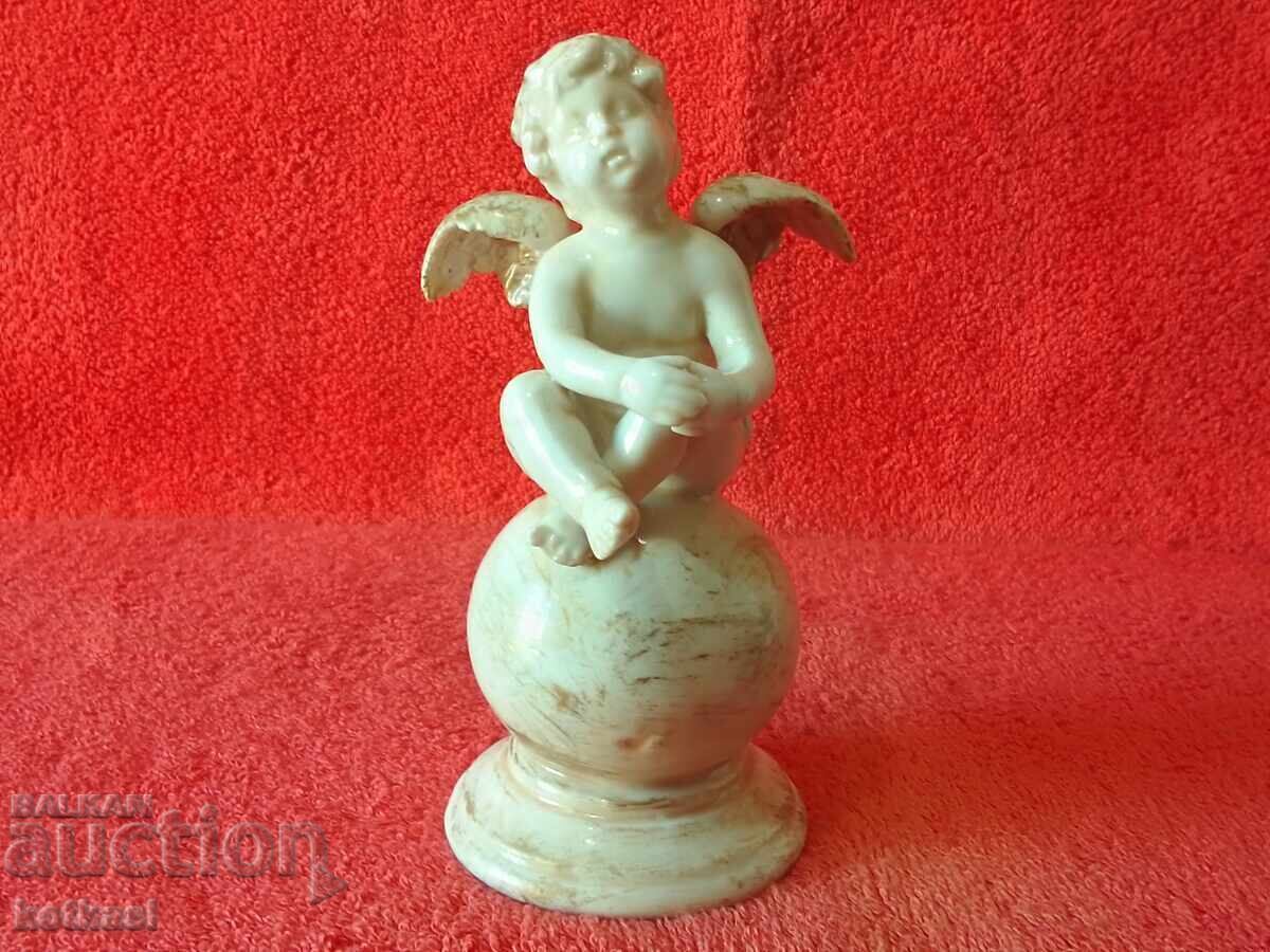 Old Porcelain Figure of an Angel Sitting on a Ball