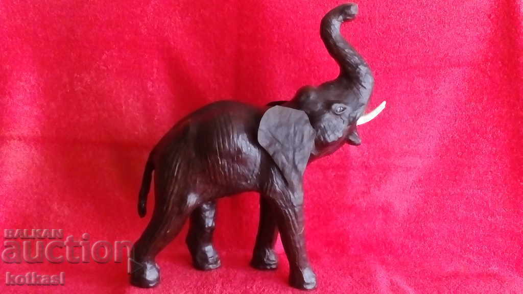Old figure of an Elephant, height 35 cm. Wood, Leather Old figure of an Elephant, height 35 cm. Wood, Leather