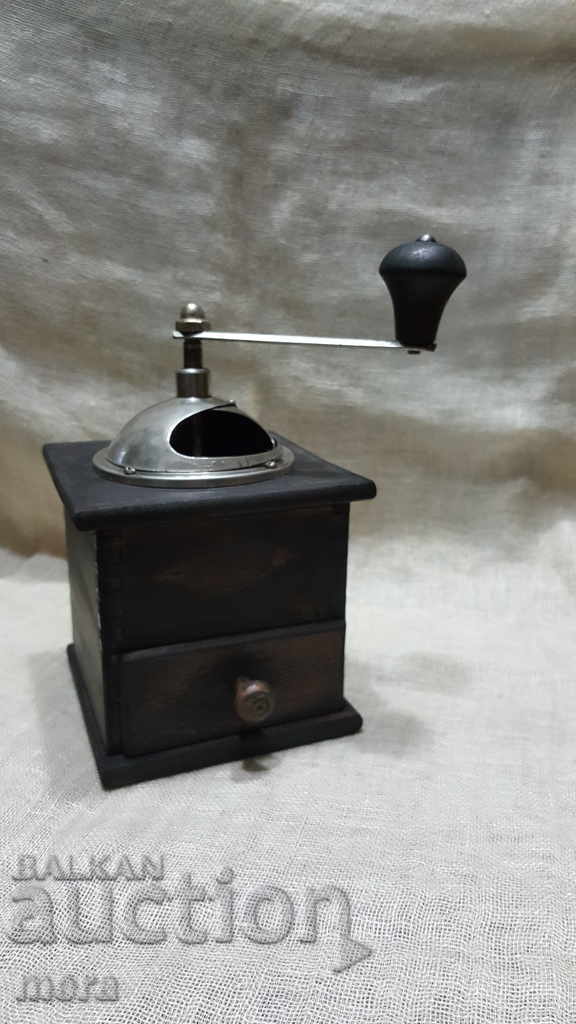 An old coffee grinder with a drawer