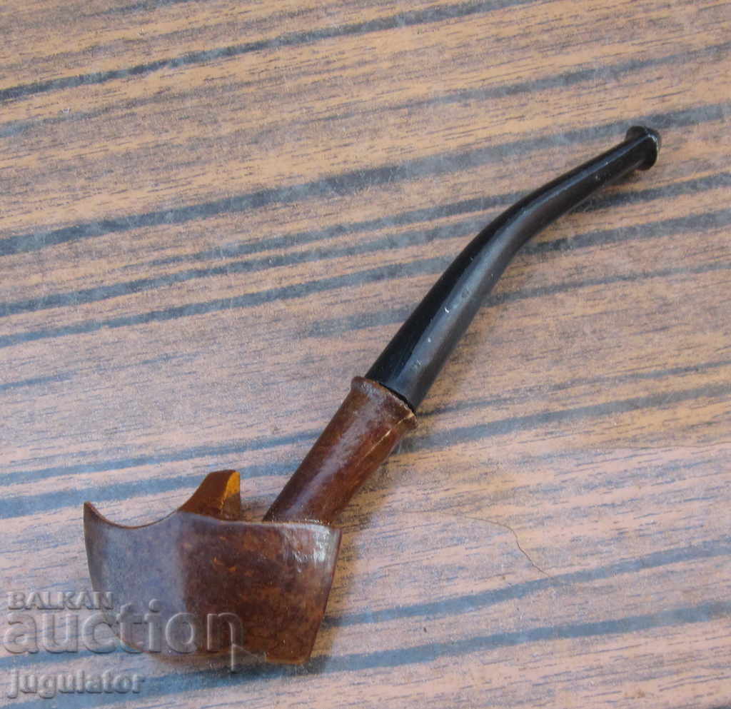 Old antique National Revival cigarette holder pipe in the shape of a traditional leather shoe (tsarvul)