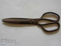 Old, massive, hand-forged scissors.