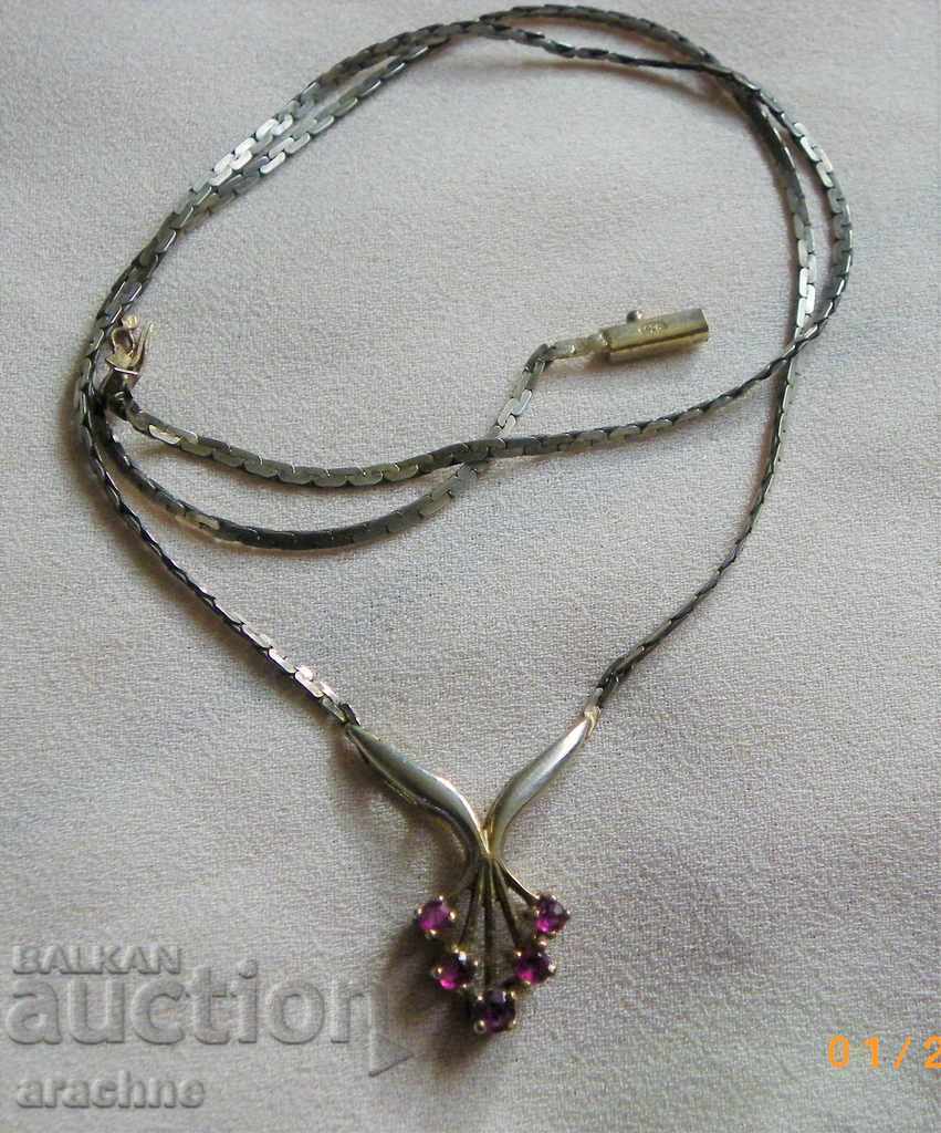 An old silver necklace with rubies
