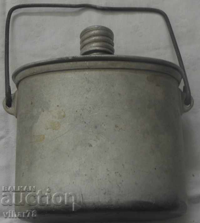 An old military canteen with a can
