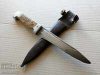 An old hunting knife with a dagger dagger, a blade