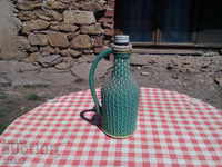 Old knitted damajana, bottle