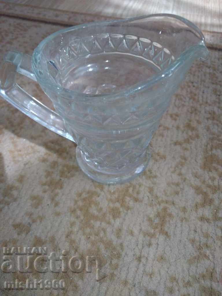 a small glass milk jug