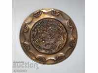 Old brass decorative plate for wall with bird Phoenix