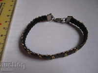 Elegant black bracelet with gold and clasp
