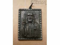A small metal icon of Jesus Christ blessing