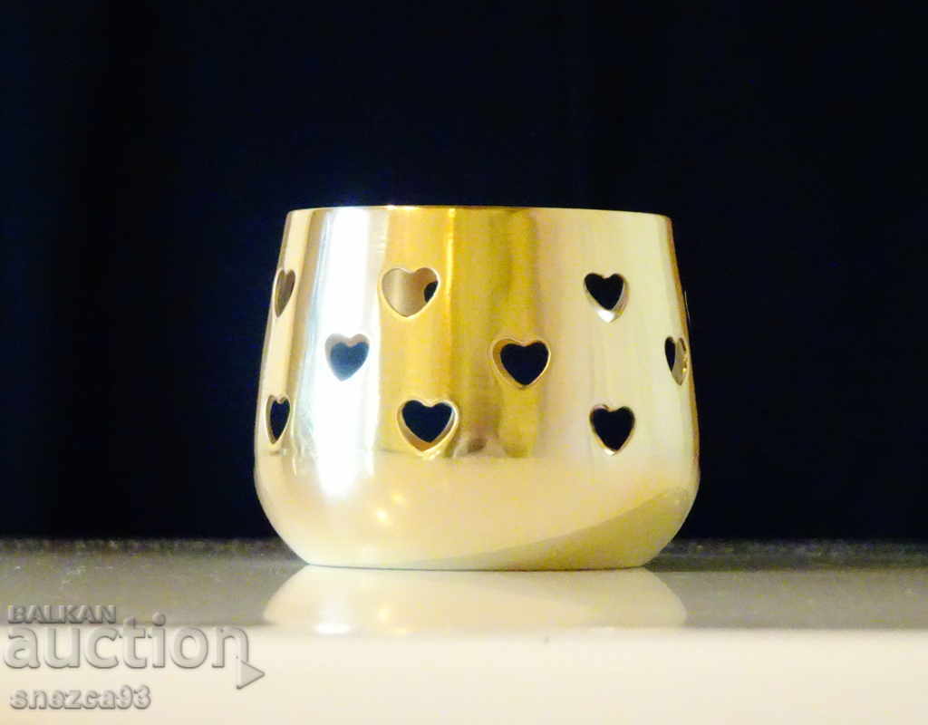 Brass candlestick with openwork hearts. Brass candlestick with openwork hearts.