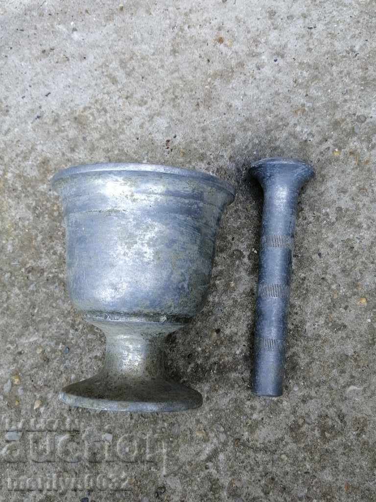 Delivery of Old white metal mortar, pestle, mortar Delivery of Old white metal mortar, pestle, mortar