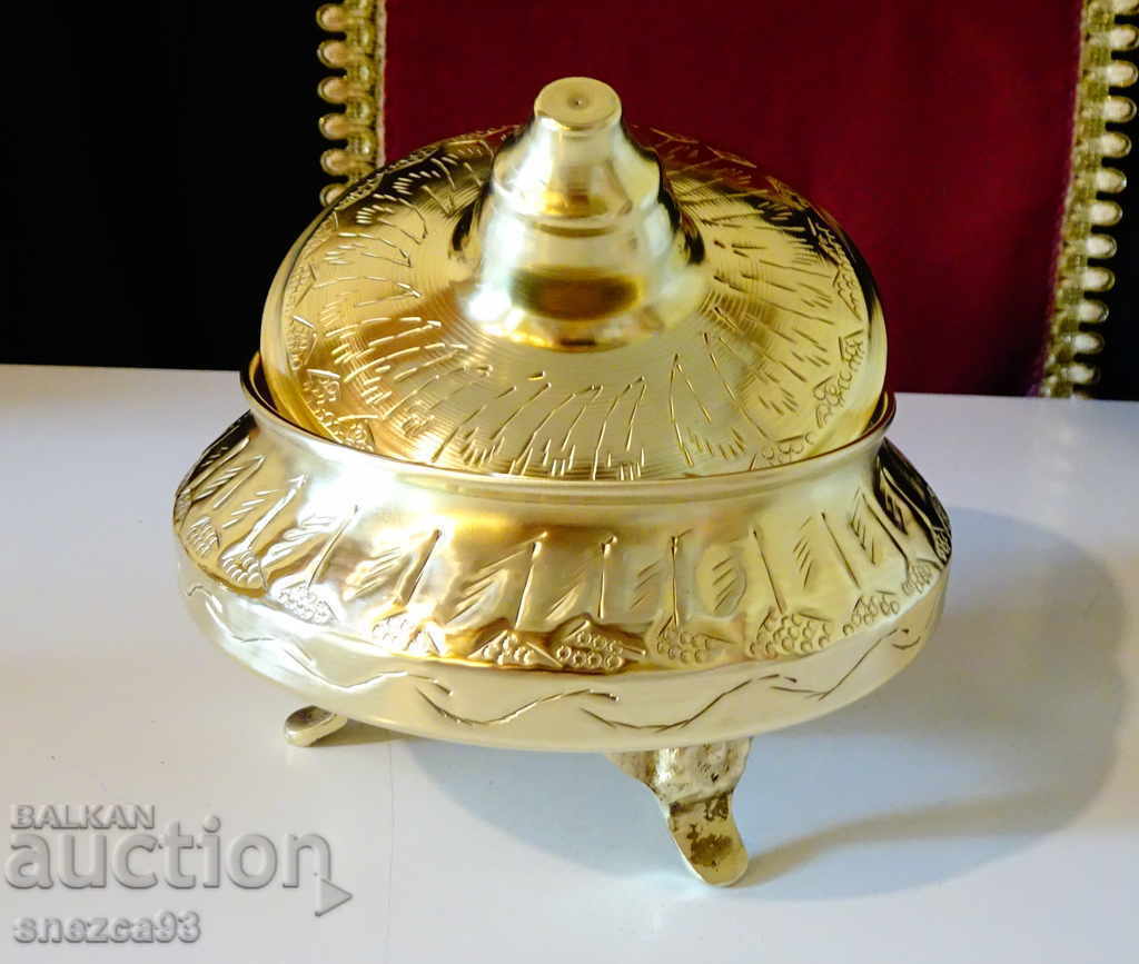 Antique sugar bowl made of brass, ornaments.