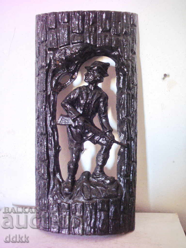 Old cast iron panel with a hunter