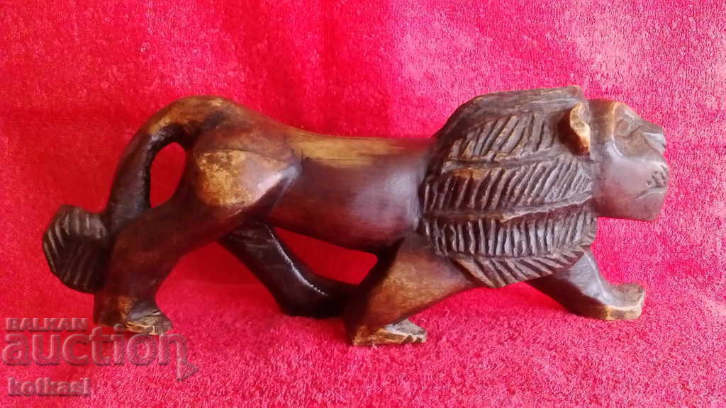 Old wood carving figure of a guardian Lion Old wood carving figure of a guardian Lion