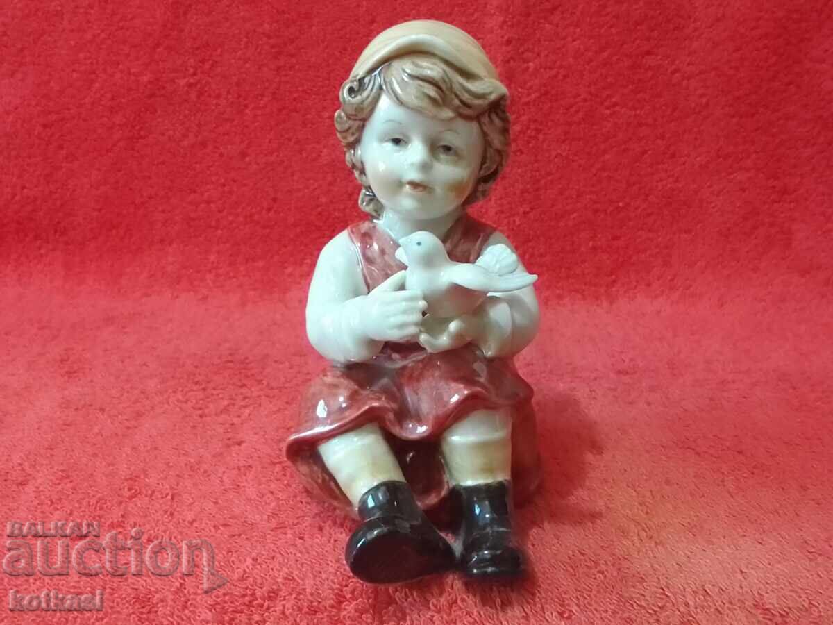 Old porcelain figure Girl with a dove Old porcelain figure Girl with a dove