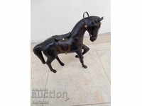 Old leather statuette on a horse