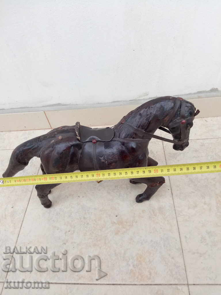 Auction  Old leather statuette on a horse