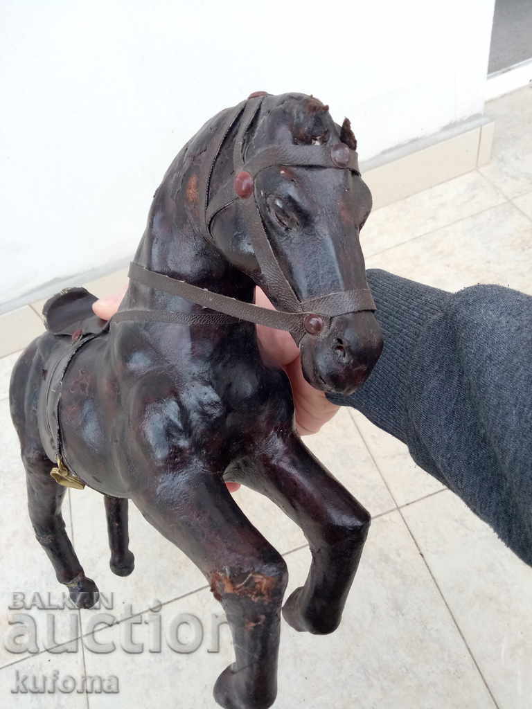 Delivery of Old leather statuette on a horse