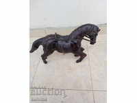 Old leather statuette on a horse