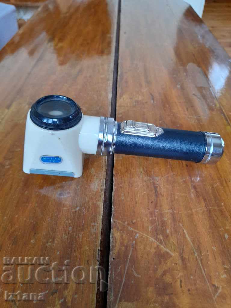 Old flashlight with magnifying glass