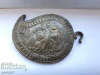 Silver religious buckle.