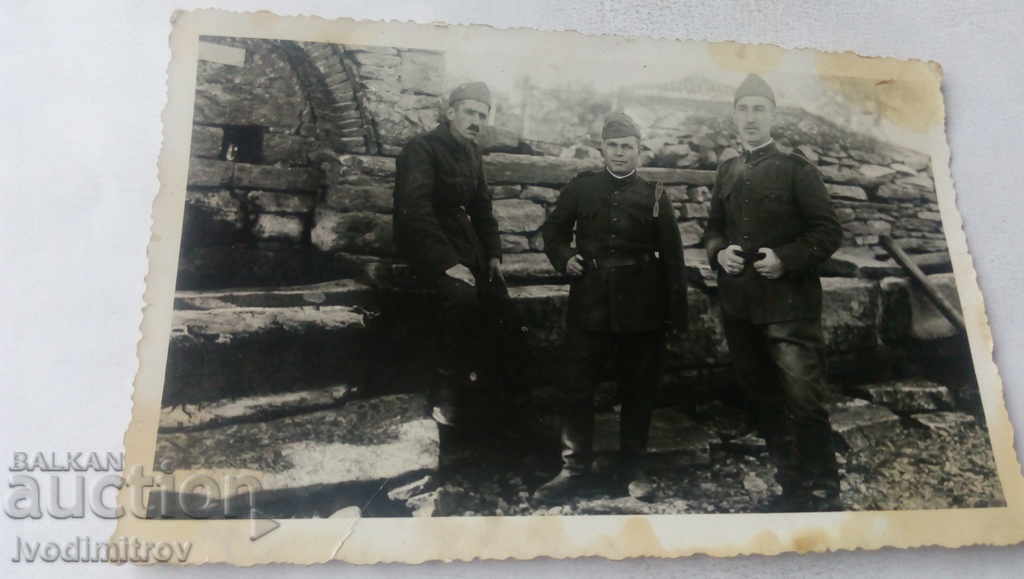 Photo Three soldiers next to the village fountain