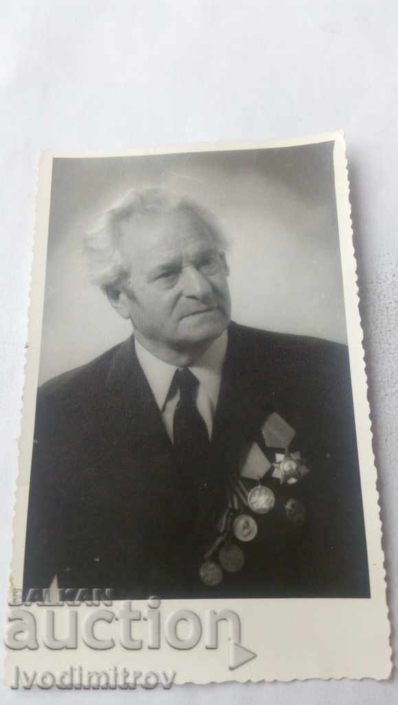 Photo An elderly man with orders and medals