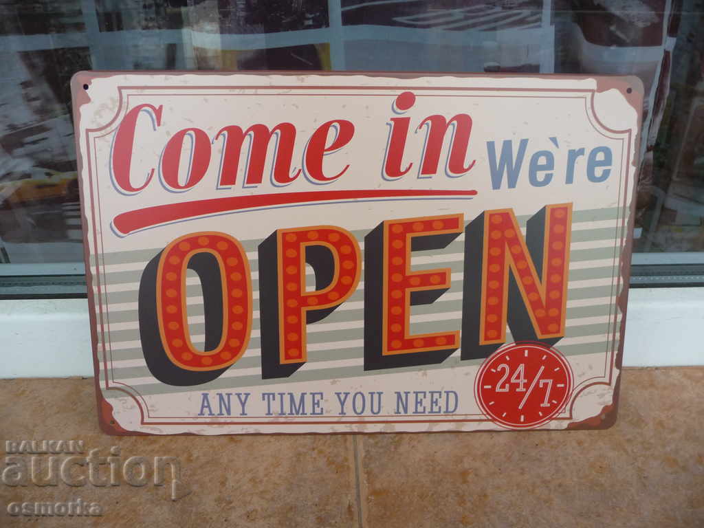 Metal sign saying Open 24/7 at any time store