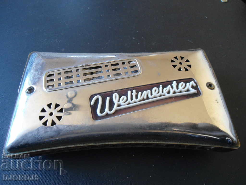 Ancient two-sided harmonica Weltmeister