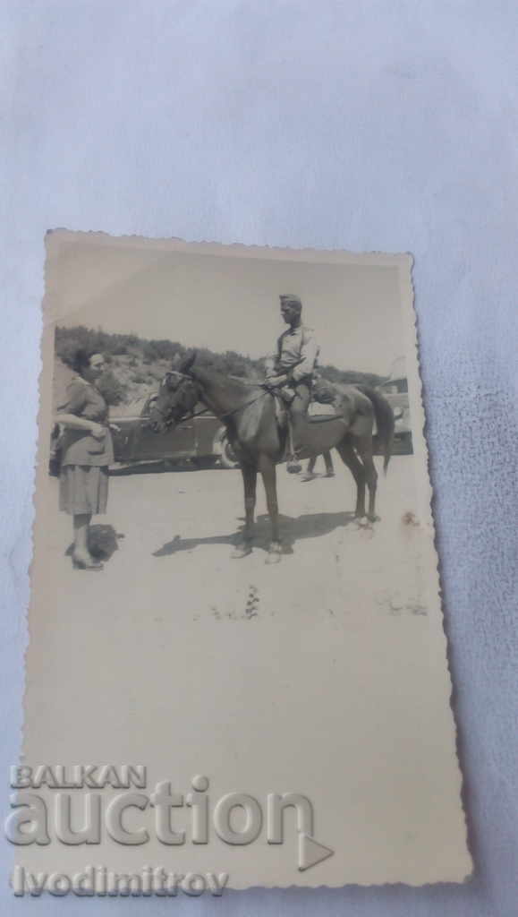 Photo Officer on horseback in front of a retro car