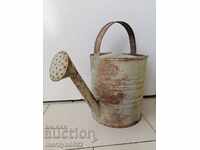 Old metal watering can of the 1940s