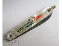 Old pocket knife with rocket space keychain