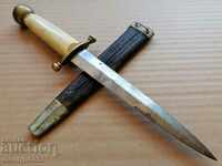Old 20th century combat dagger with a white bone handle and handle