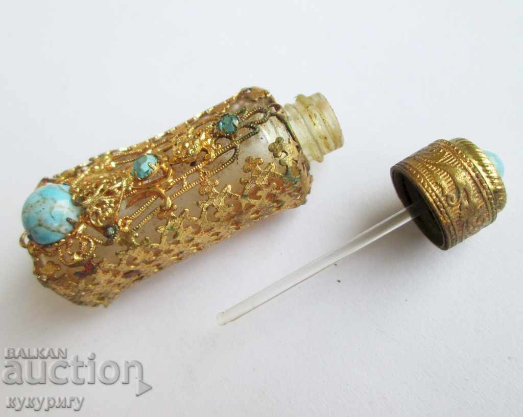 Delivery of Old antique perfume bottle with gilded ornaments