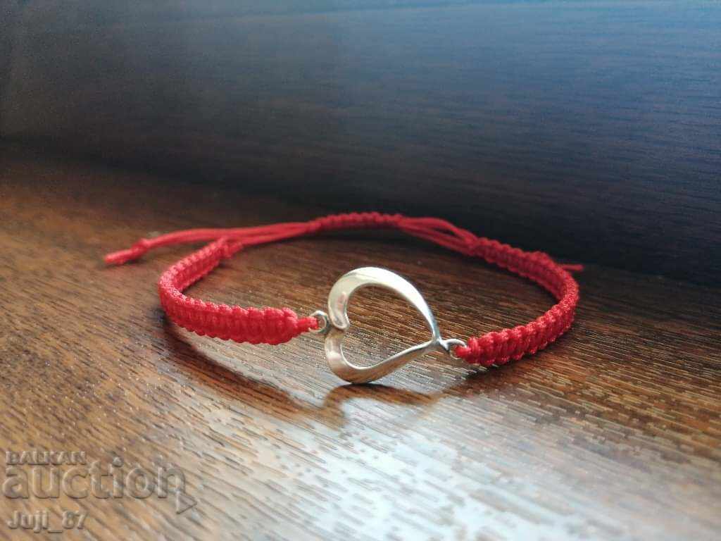 New silver bracelet with red thread.