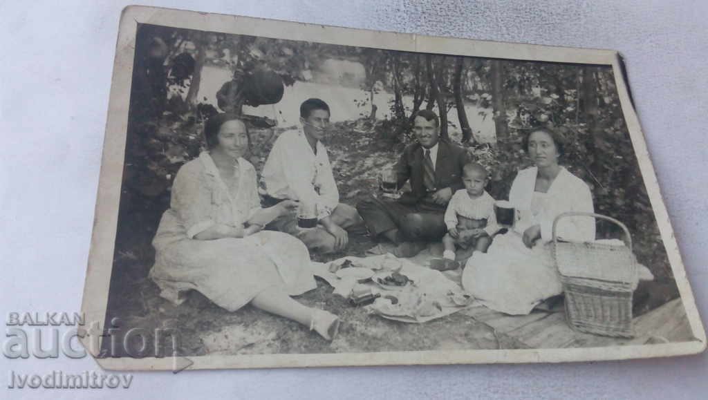 S-ka Kazichene Family on a picnic on the lawn with mugs of beer